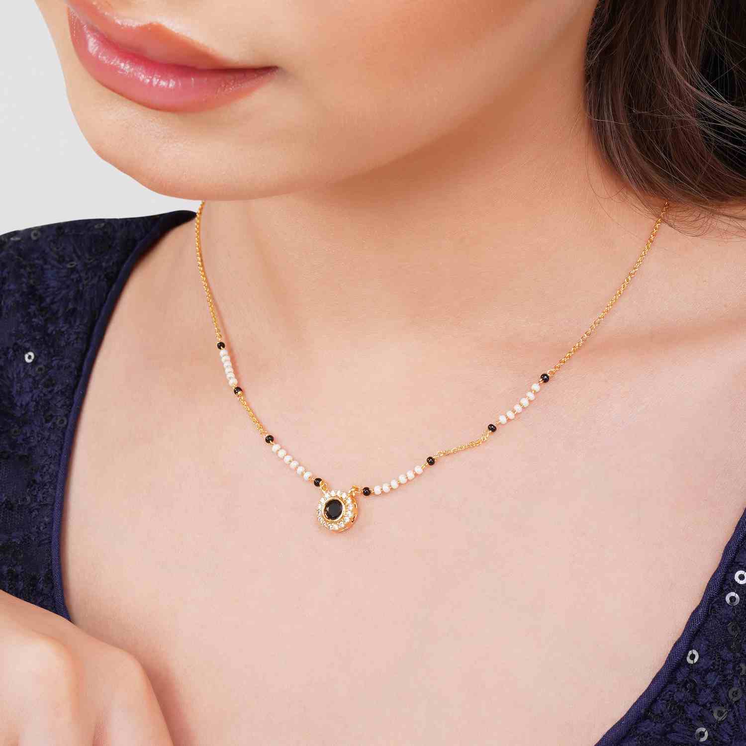 Shraddha gold plated mangalsutra with white background 
